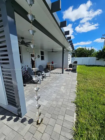 a view of a backyard with sitting area