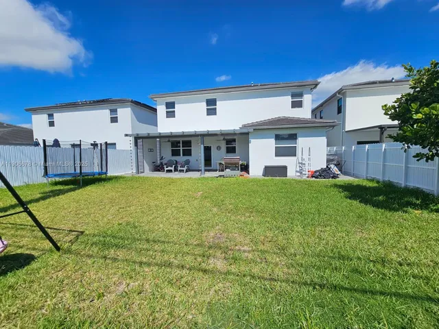 a view of a house with a backyard