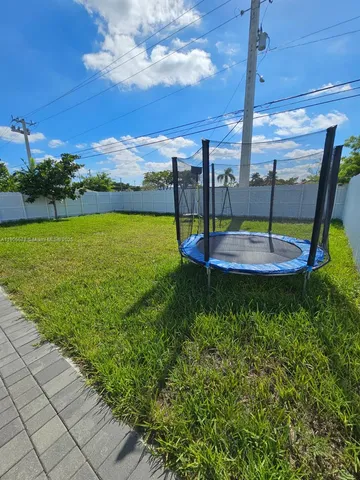 a view of a swimming pool with a yard