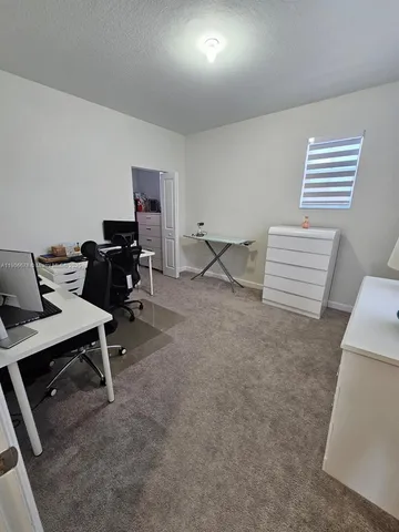 a view of a workspace with furniture