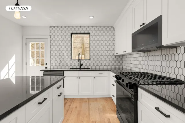a kitchen with granite countertop a refrigerator and a sink