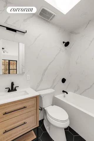 a spacious bedroom with a bed couch and a large window