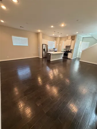 a kitchen with kitchen island a refrigerator stove and sink