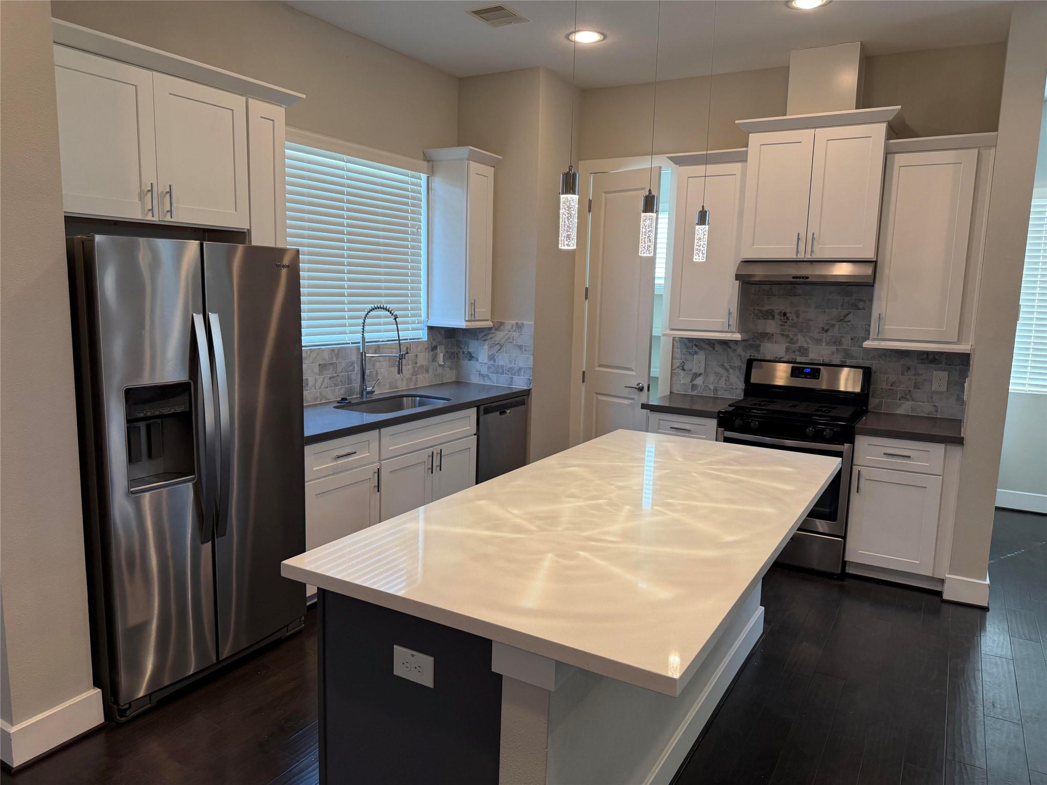 10806 Warwana Road, Unit A Houston, TX 77043 - Photo 17 of 37 a kitchen with kitchen island a refrigerator stove and sink