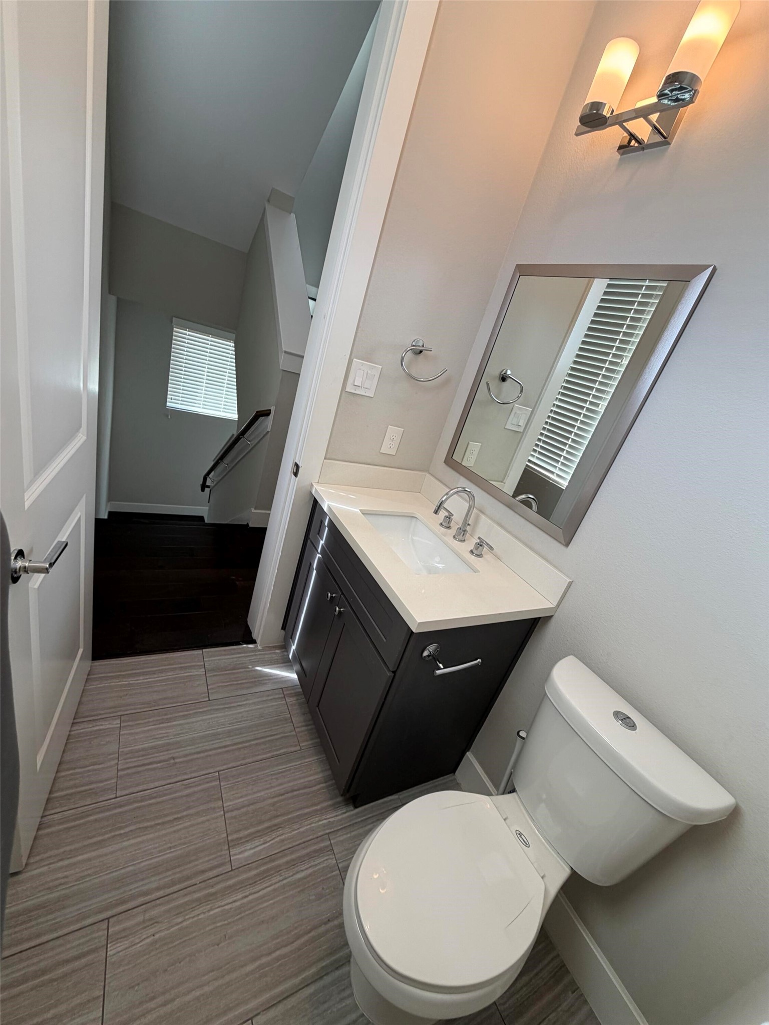 10806 Warwana Road, Unit A Houston, TX 77043 - Photo 21 of 37 a bathroom with a toilet sink and mirror
