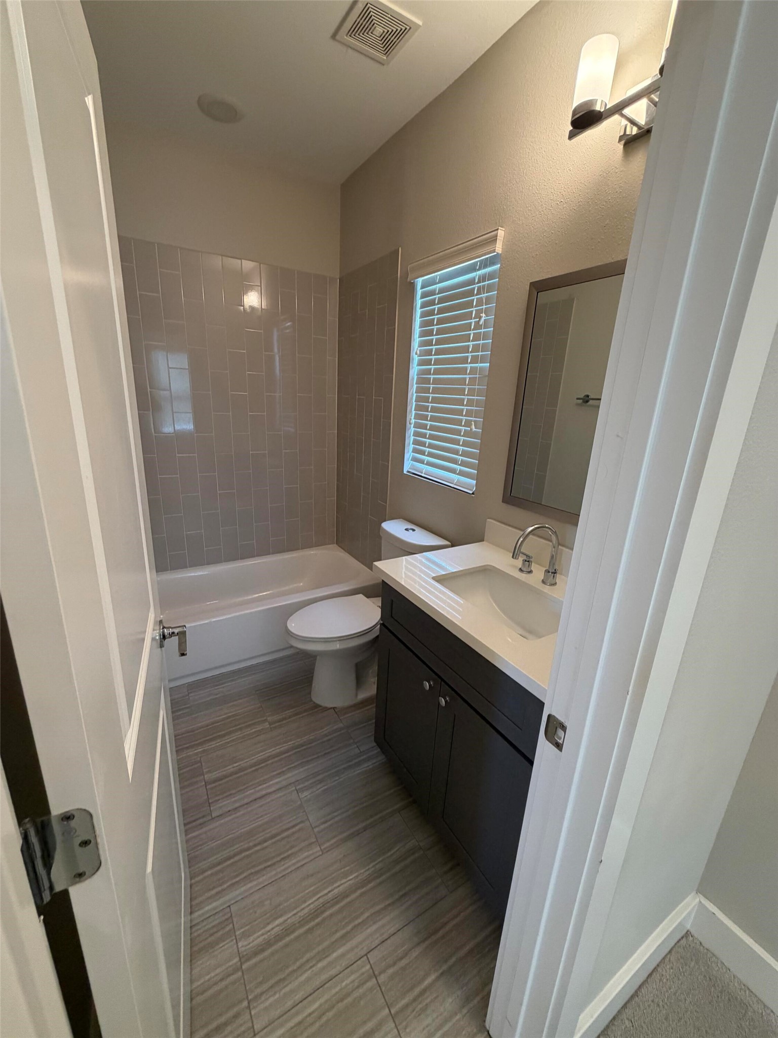 10806 Warwana Road, Unit A Houston, TX 77043 - Photo 29 of 37 a bathroom with a sink a toilet a mirror and shower