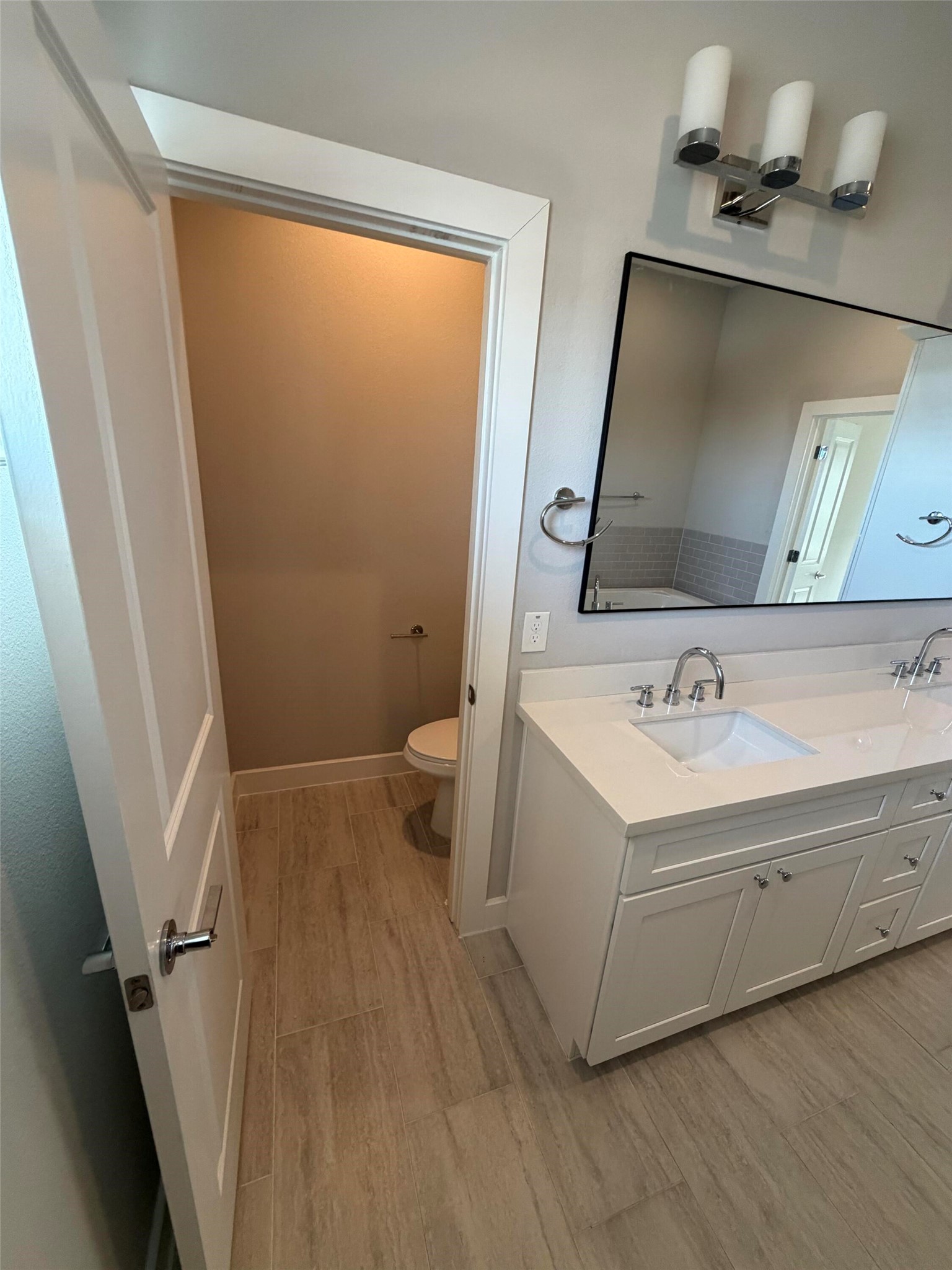 10806 Warwana Road, Unit A Houston, TX 77043 - Photo 36 of 37 a bathroom with a sink a mirror and a toilet