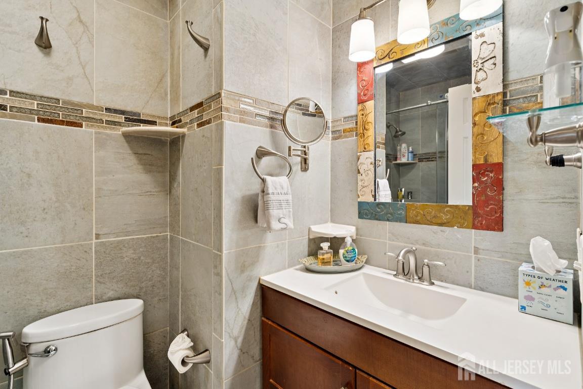 118 Coppertree Court Edison, NJ 08820 - Photo 16 of 38 a bathroom with a granite countertop sink a toilet and a shower