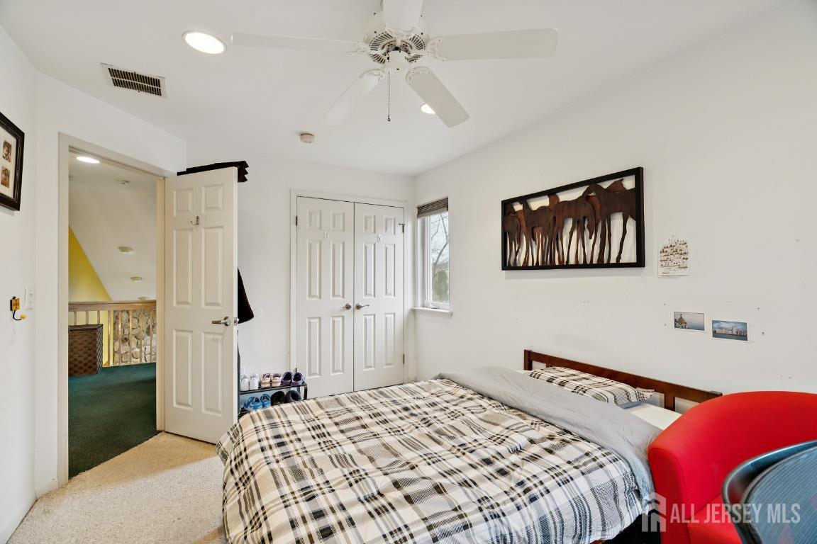 118 Coppertree Court Edison, NJ 08820 - Photo 18 of 38 a bedroom with a bed and a chandelier
