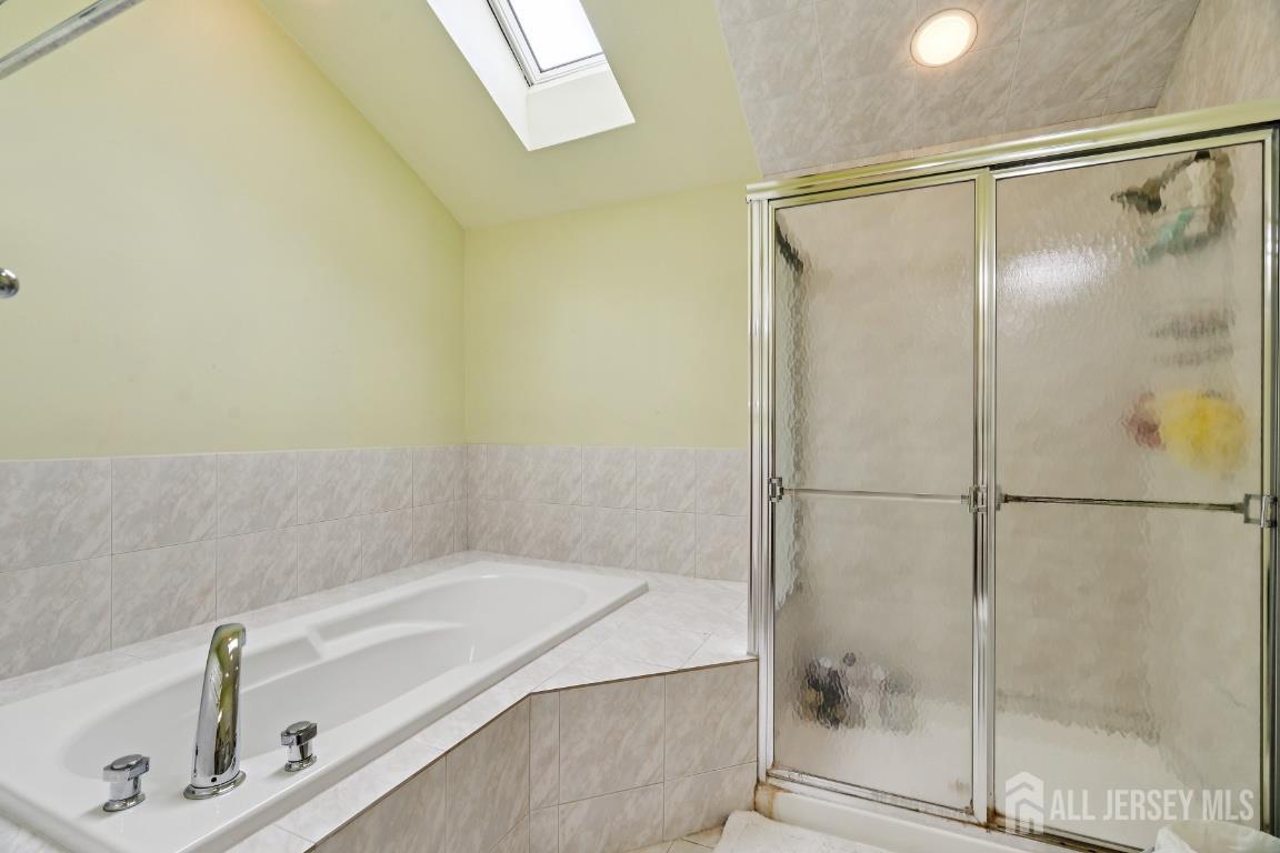 118 Coppertree Court Edison, NJ 08820 - Photo 21 of 38 a bathroom with a tub and a shower