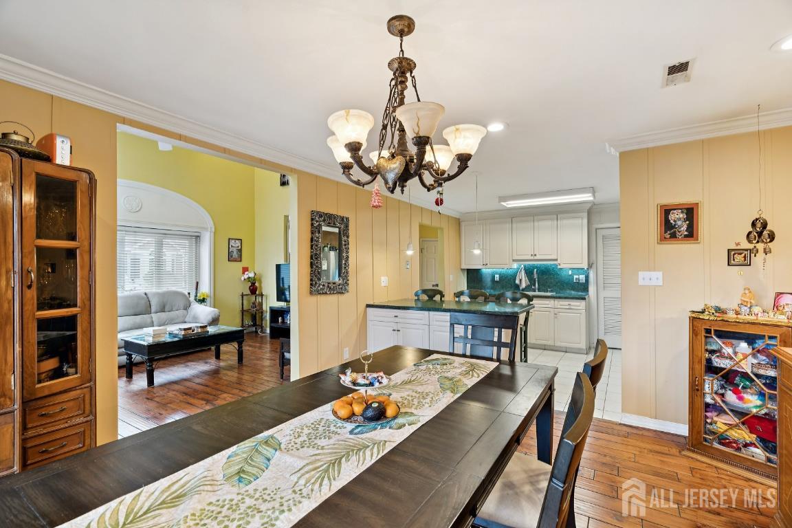118 Coppertree Court Edison, NJ 08820 - Photo 9 of 38 a view of a dining room with furniture wooden floor and a chandelier