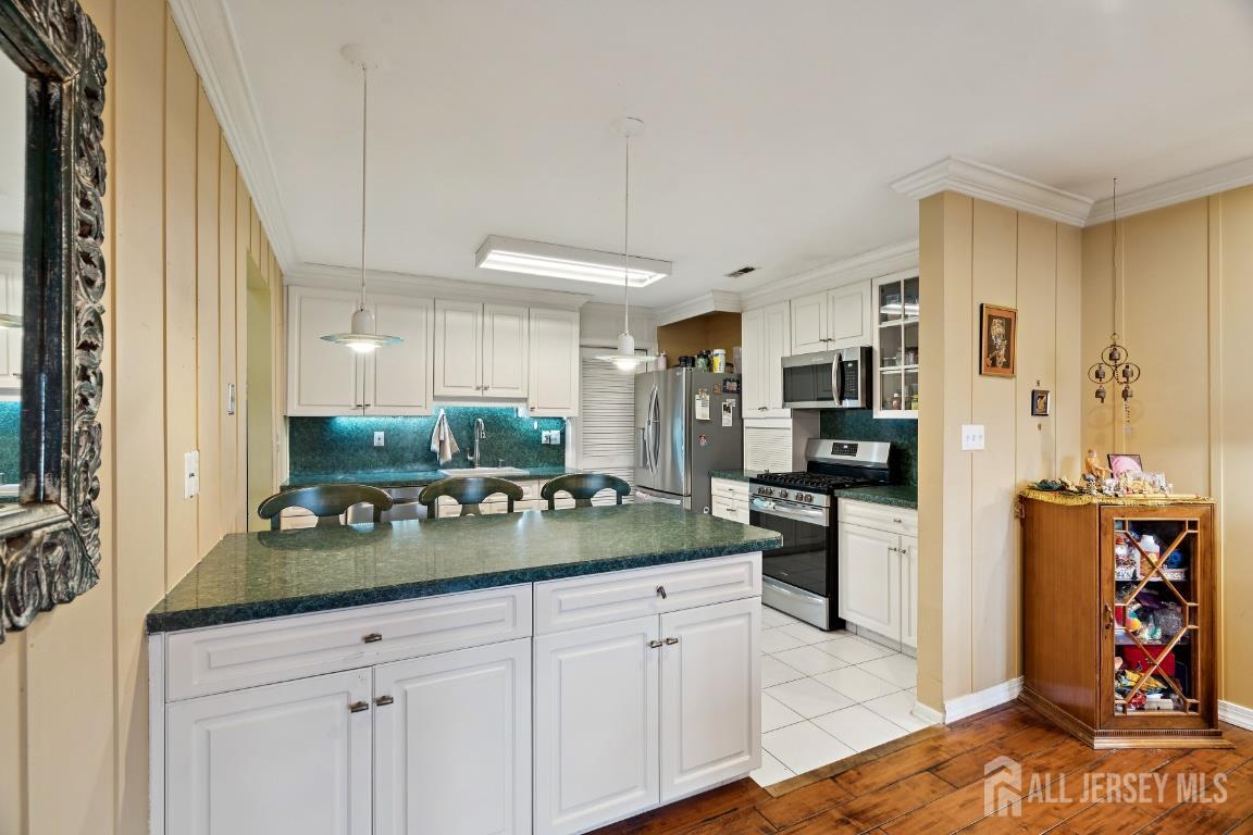 118 Coppertree Court Edison, NJ 08820 - Photo 10 of 38 a kitchen with stainless steel appliances kitchen island granite countertop a refrigerator and stove