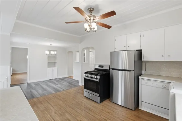 a kitchen with a refrigerator and a stove top oven