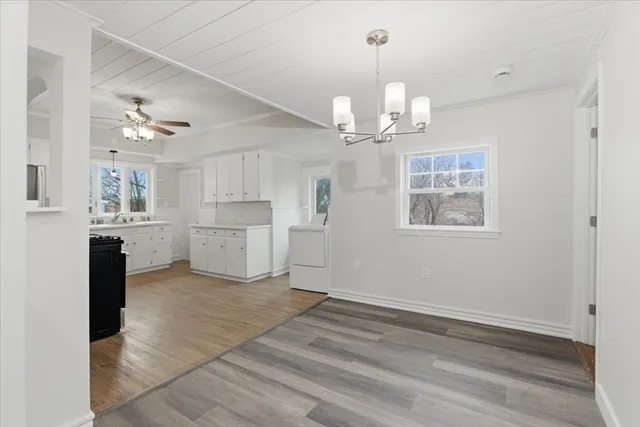 a view of a kitchen with a sink dishwasher a refrigerator and a stove top oven