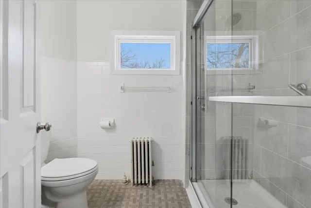 a bathroom with a glass shower door