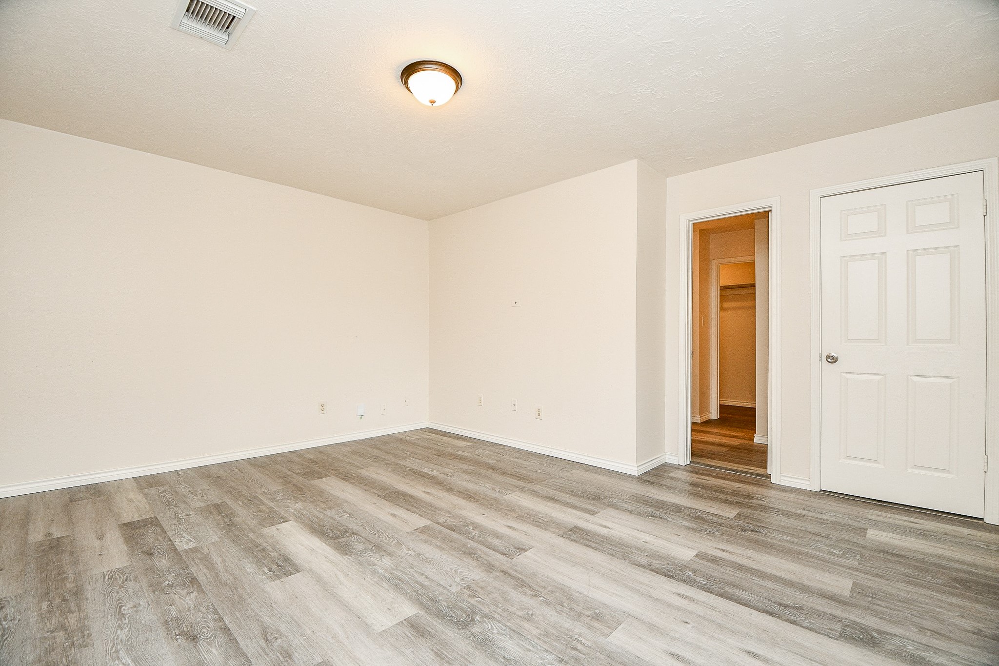 10919 Rustling Winds Drive Houston, TX 77064 - Photo 12 of 20 an empty room with wooden floor and windows