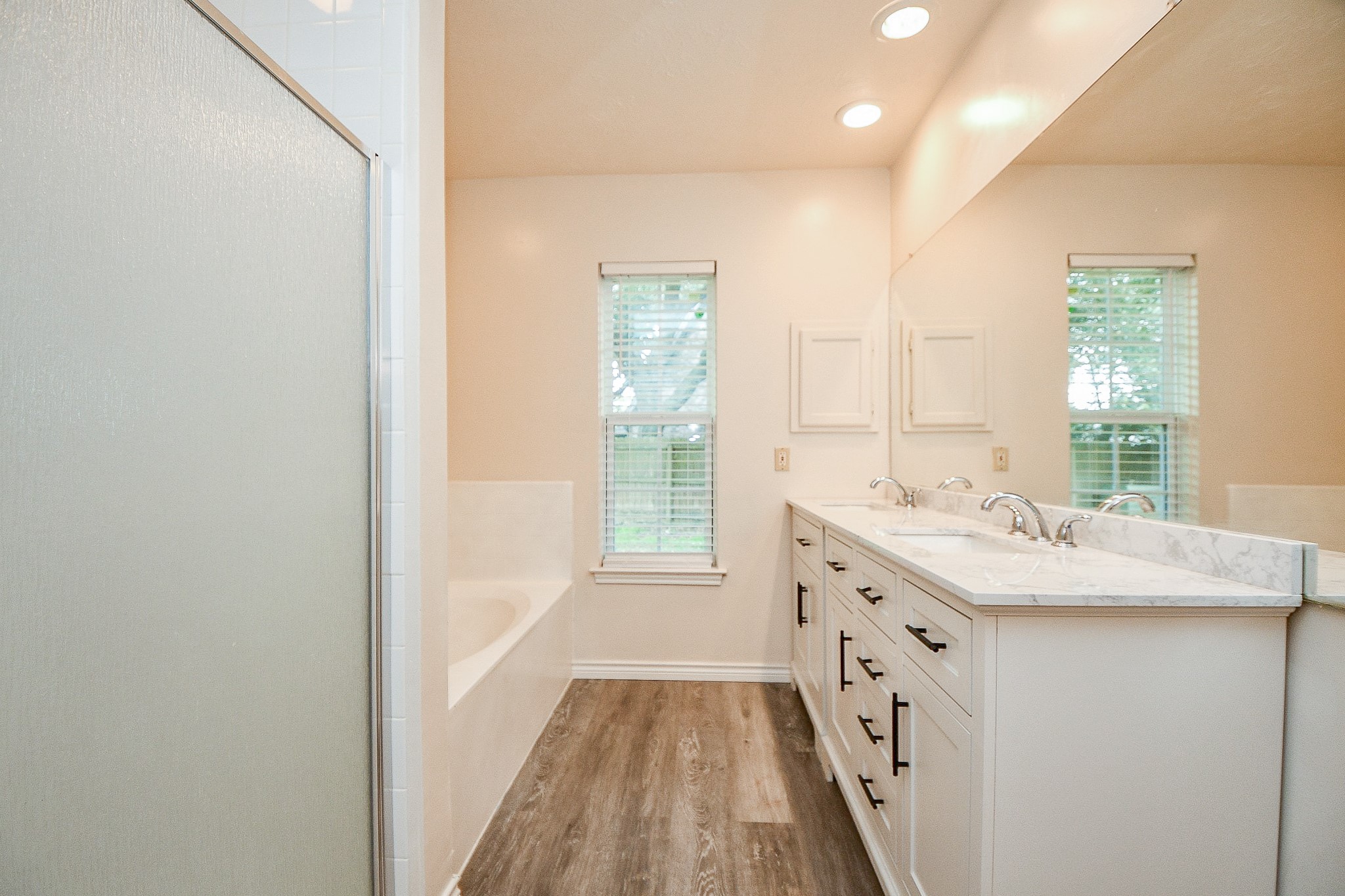 10919 Rustling Winds Drive Houston, TX 77064 - Photo 13 of 20 a bathroom with a granite countertop sink a vanity and a large mirror