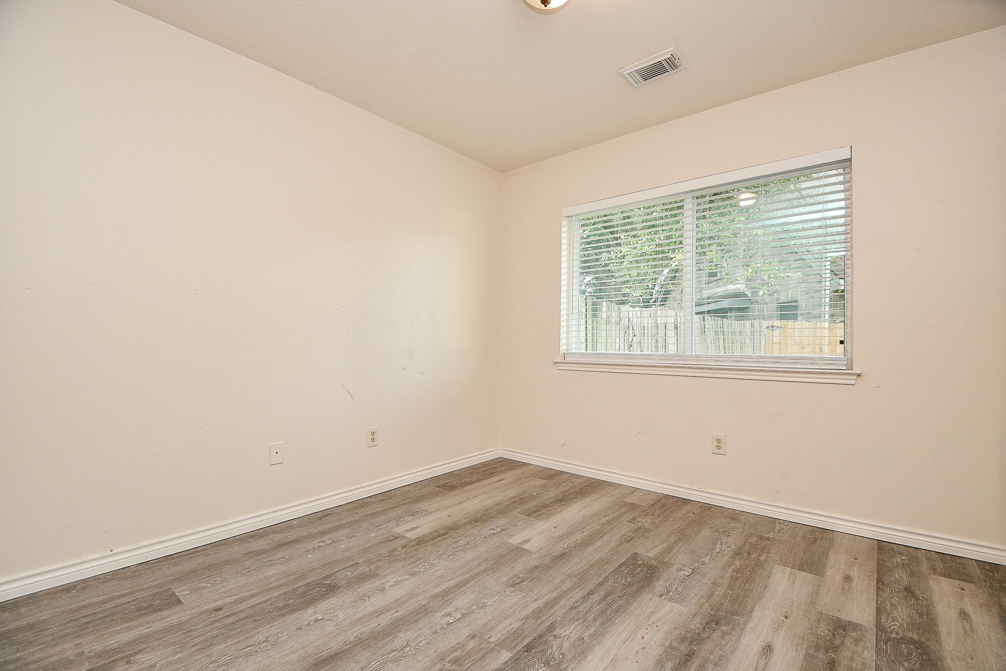 10919 Rustling Winds Drive Houston, TX 77064 - Photo 16 of 20 an empty room with wooden floor and windows