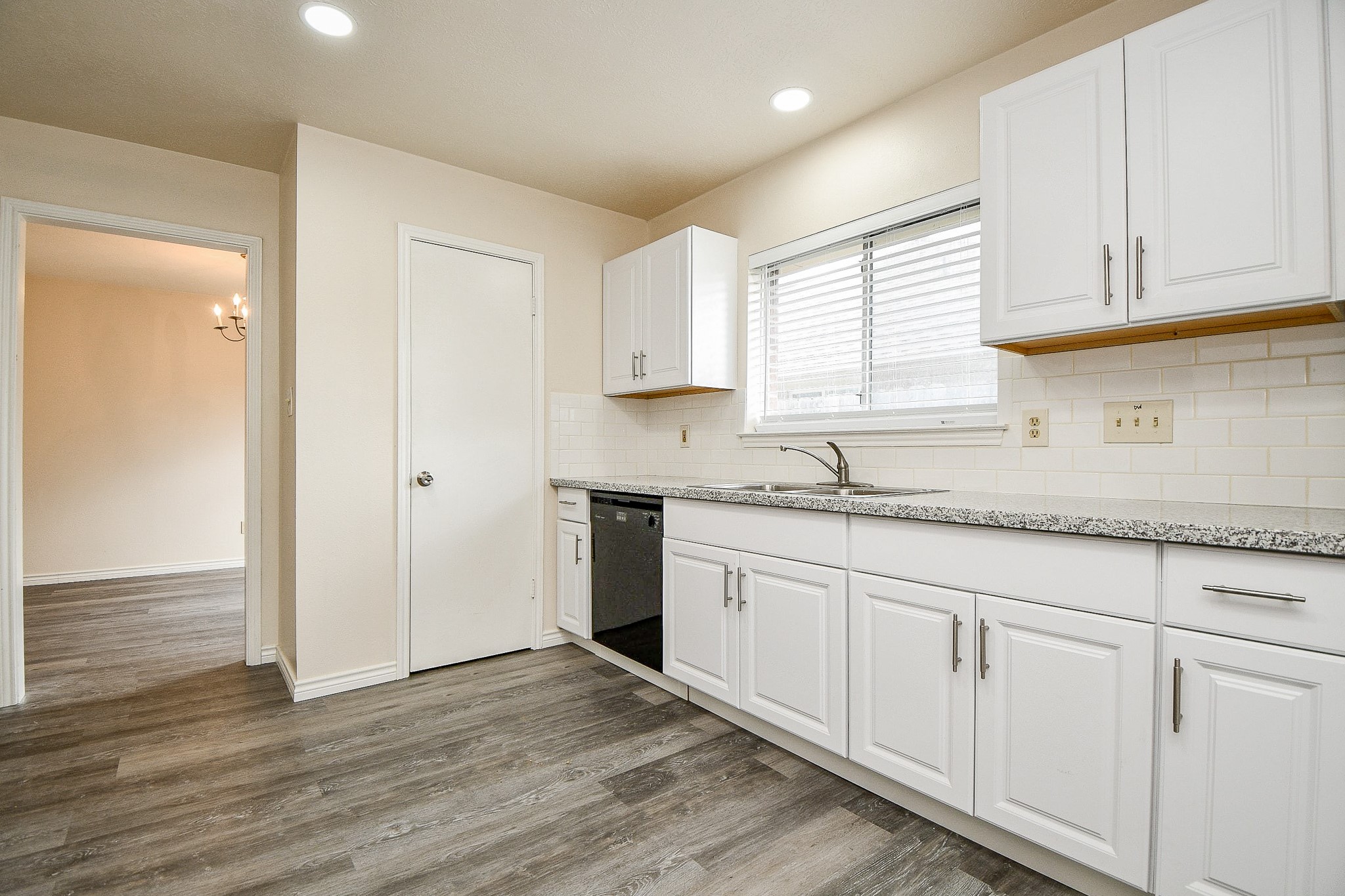 10919 Rustling Winds Drive Houston, TX 77064 - Photo 8 of 20 a kitchen with granite countertop white cabinets and a sink