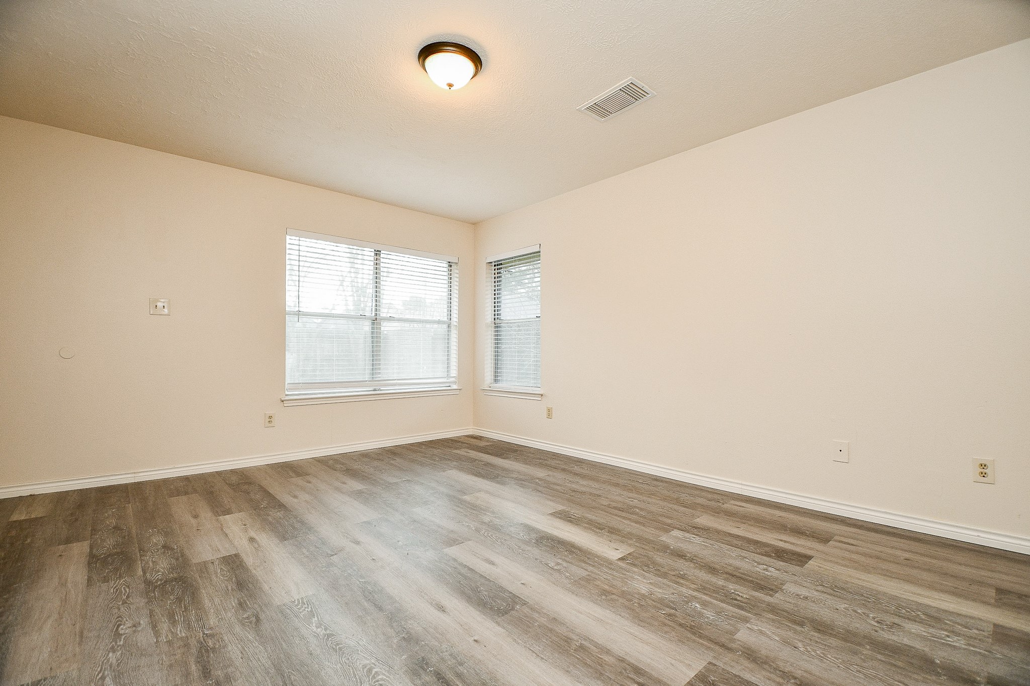 10919 Rustling Winds Drive Houston, TX 77064 - Photo 10 of 20 an empty room with wooden floor and windows