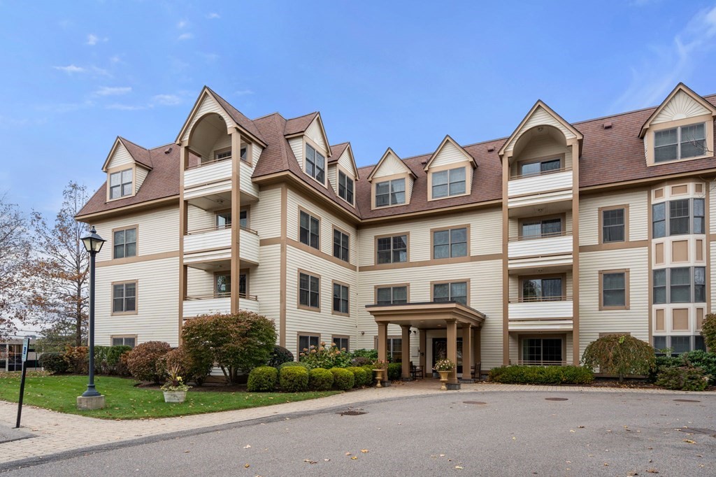 12 Russell Road, Unit 304 Wellesley, MA 02482 - Photo 1 of 16 a front view of a building with garden