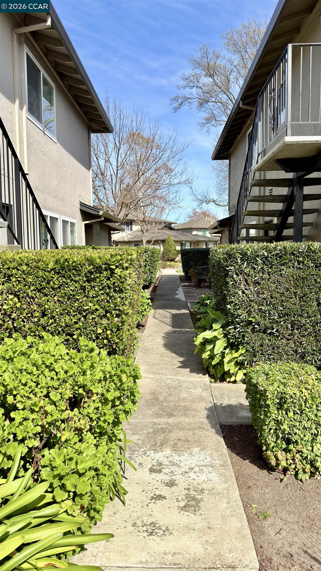 1360 Del Rio Court, Unit 4 Concord, CA 94518 - Photo 3 of 19 a front view of a house with a yard