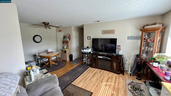 a living room with furniture a flat screen tv and a floor to ceiling window