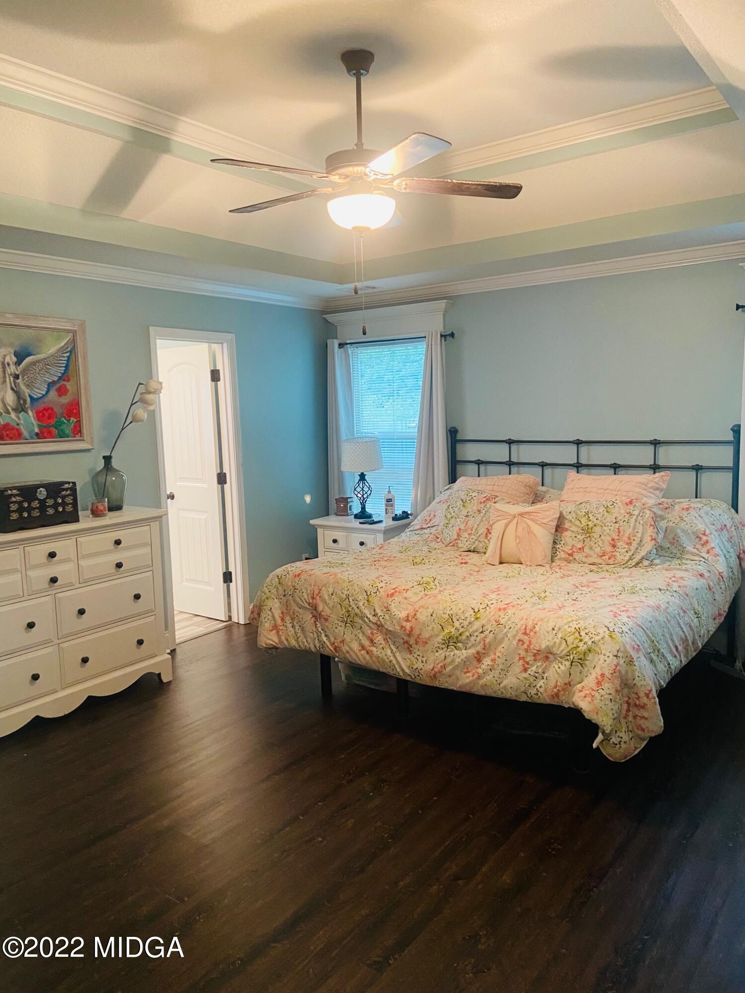 304 Durgin Drive Bonaire, GA 31005 - Photo 14 of 22 a bedroom with a bed and wooden floor