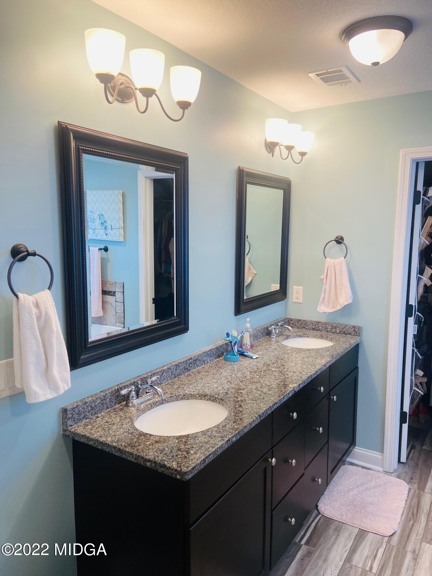304 Durgin Drive Bonaire, GA 31005 - Photo 17 of 22 a bathroom with a granite countertop sink and a mirror