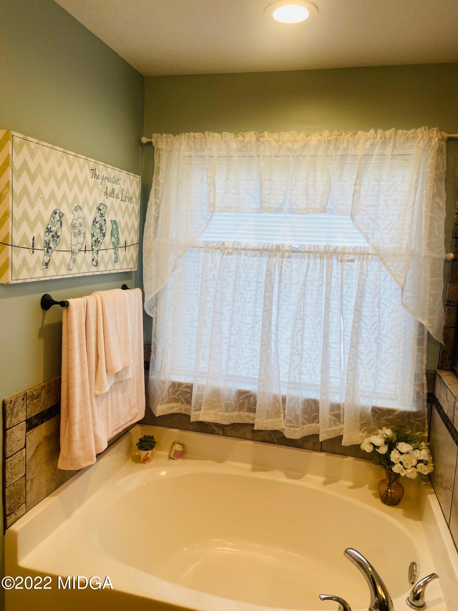 304 Durgin Drive Bonaire, GA 31005 - Photo 18 of 22 a bathroom with a tub and a window