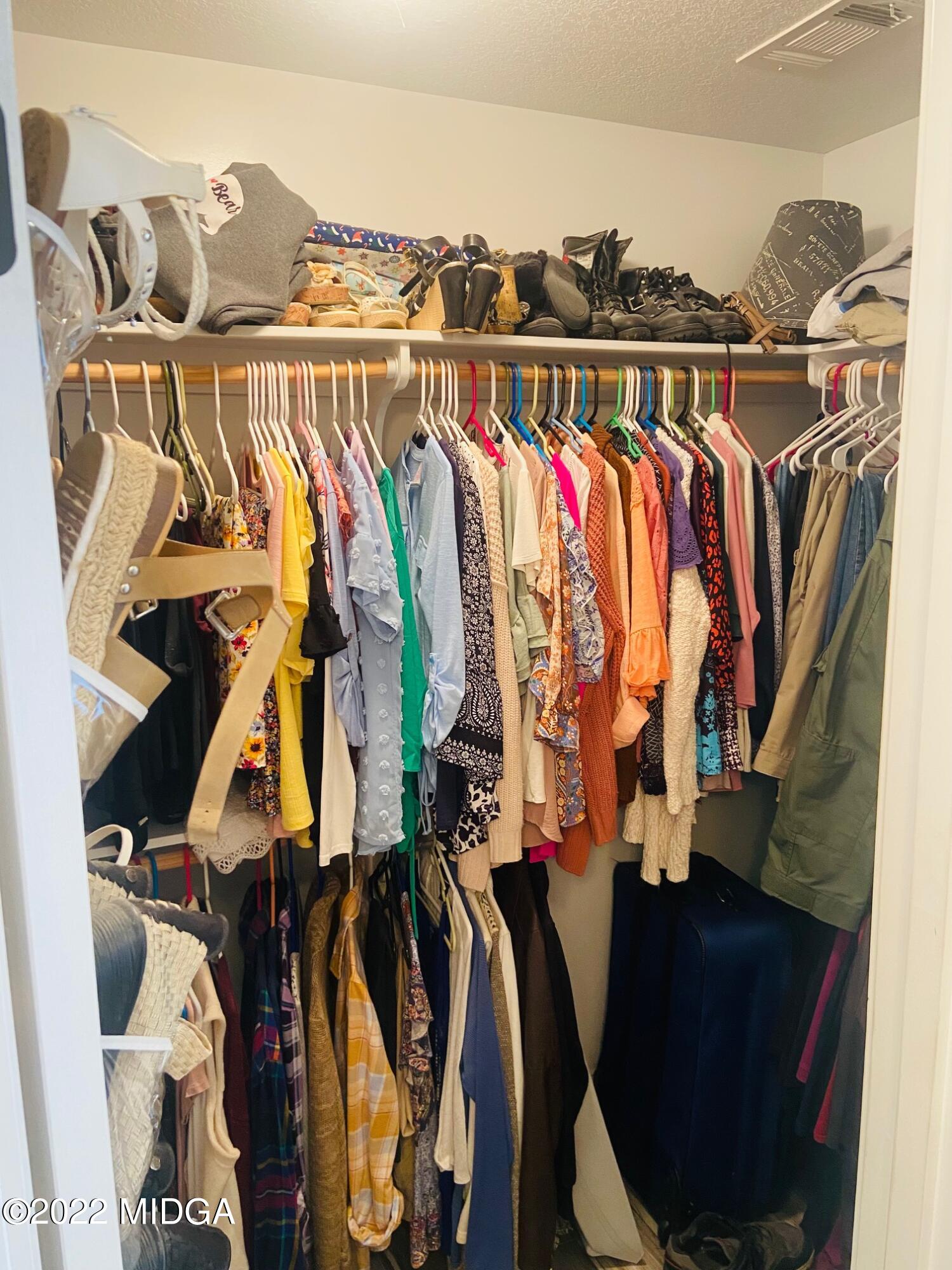 304 Durgin Drive Bonaire, GA 31005 - Photo 19 of 22 a view of walk in closet with clothes and shoes