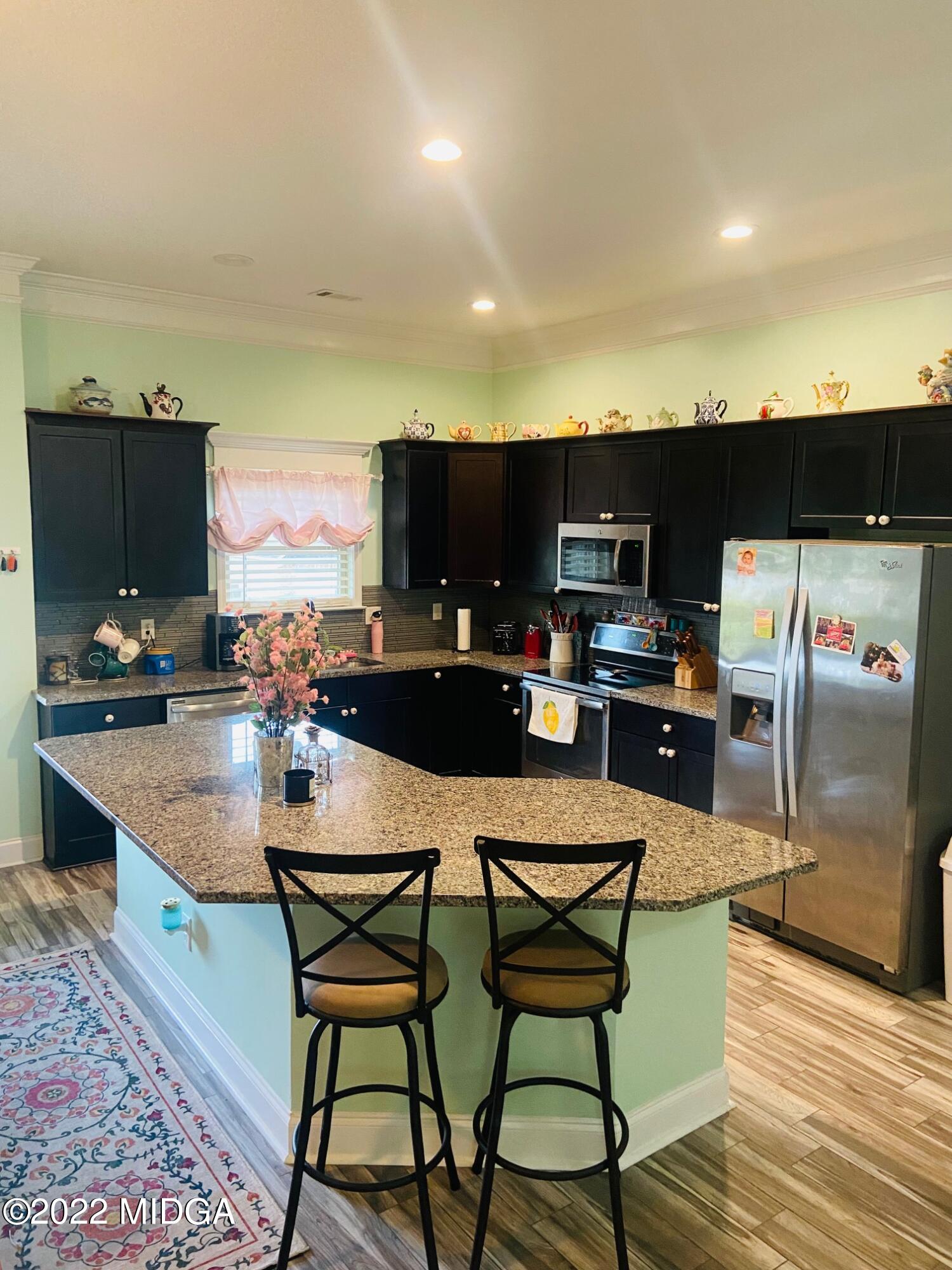 304 Durgin Drive Bonaire, GA 31005 - Photo 4 of 22 a kitchen with a table chairs refrigerator and microwave