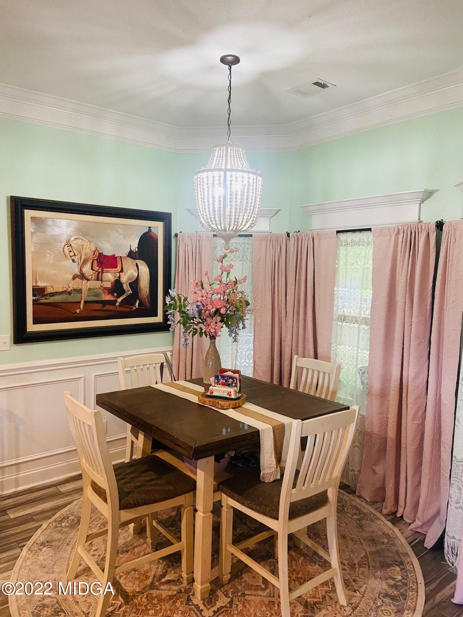 304 Durgin Drive Bonaire, GA 31005 - Photo 6 of 22 a view of a dining room with furniture wooden floor and a chandelier