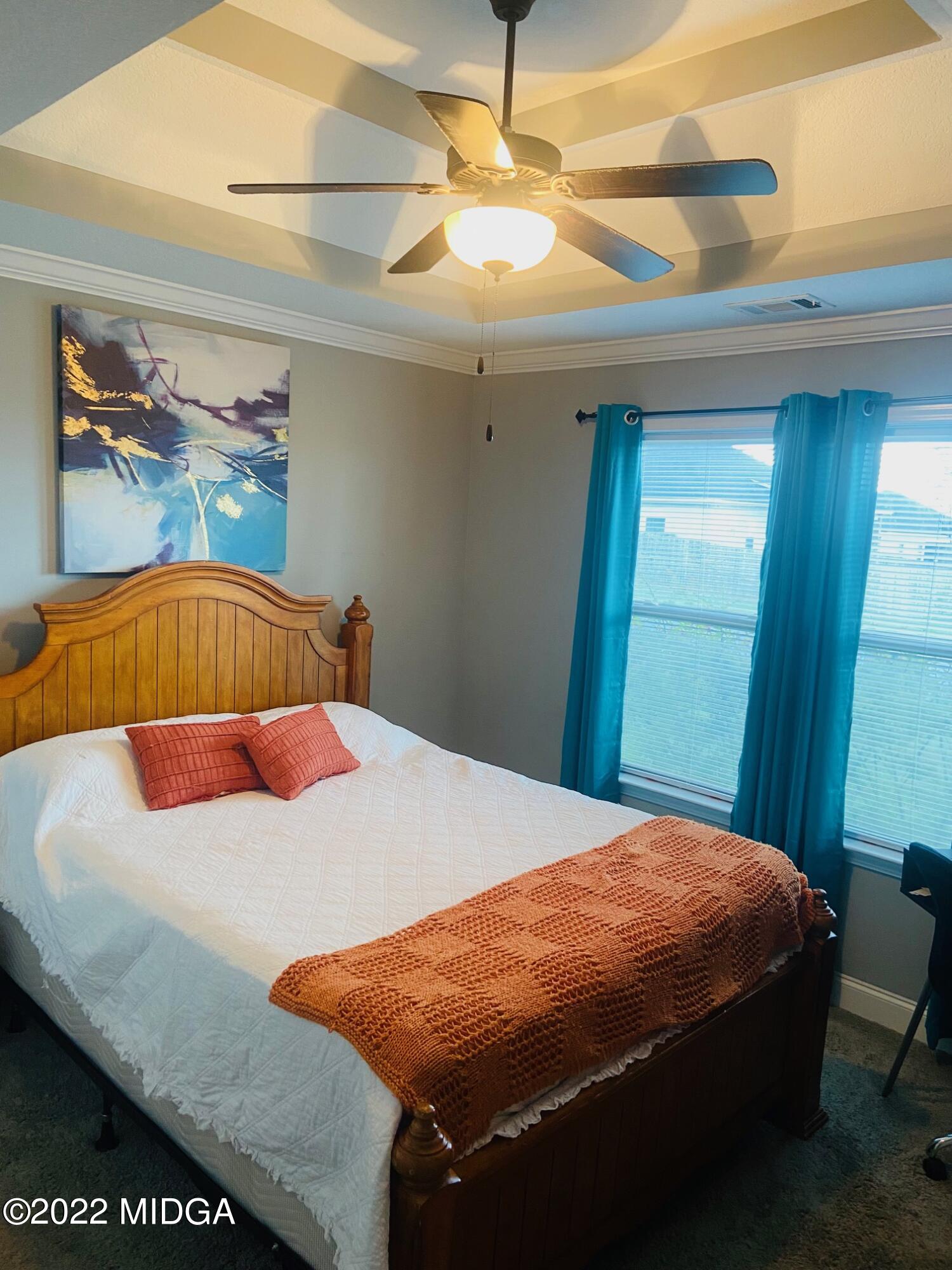 304 Durgin Drive Bonaire, GA 31005 - Photo 8 of 22 a bedroom with a bed and a chandelier