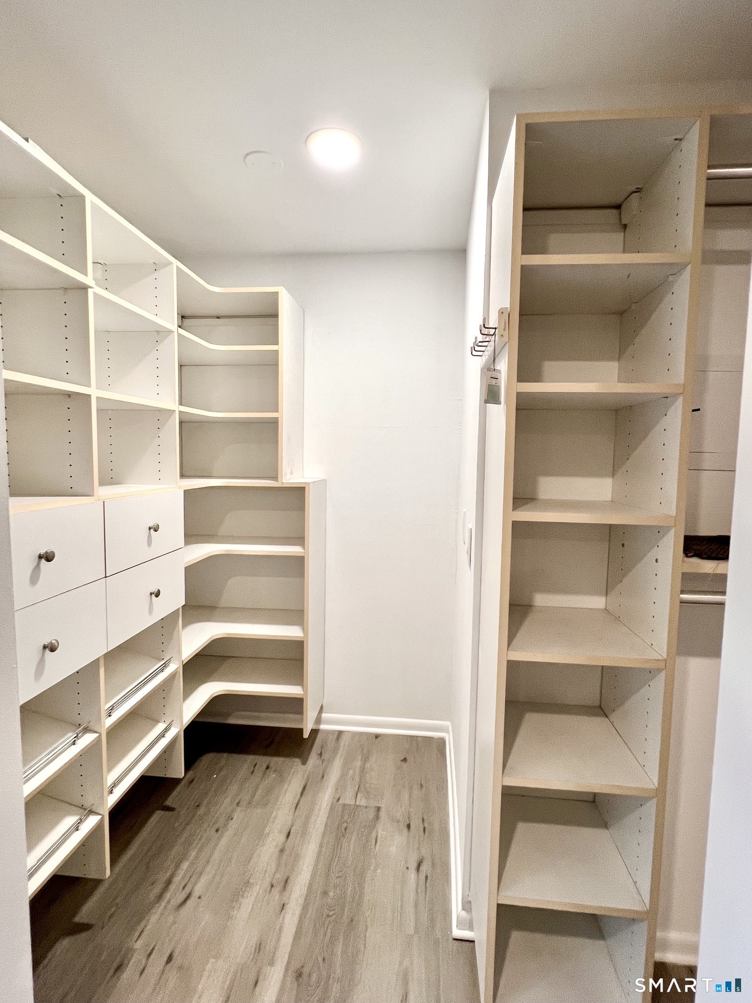 208 Flax Hill Road, Unit 32 Norwalk, CT 06854 - Photo 5 of 12 a view of walk in closet with empty racks