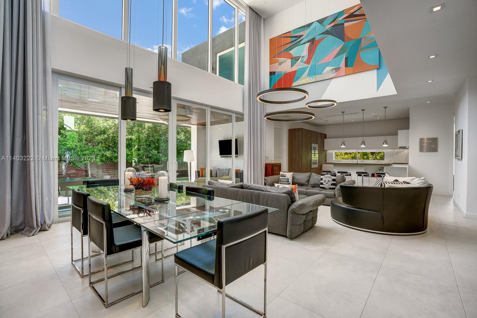 141 Harbor Drive Key Biscayne, FL 33149 - Photo 14 of 56 a living room with stainless steel appliances granite countertop a table chairs and a refrigerator