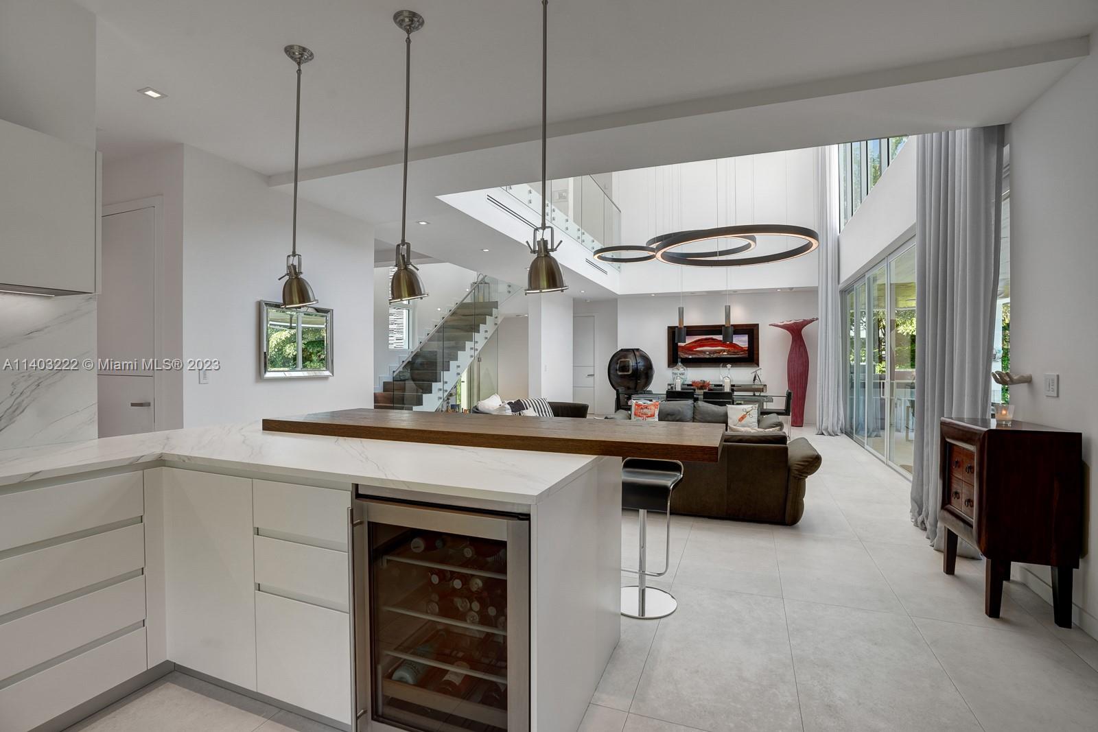 141 Harbor Drive Key Biscayne, FL 33149 - Photo 21 of 56 a kitchen with a stove a sink a window and chairs