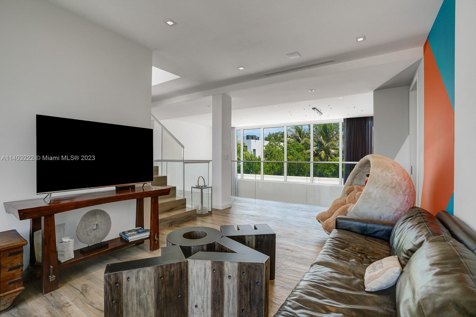 141 Harbor Drive Key Biscayne, FL 33149 - Photo 25 of 56 a living room with furniture and a flat screen tv