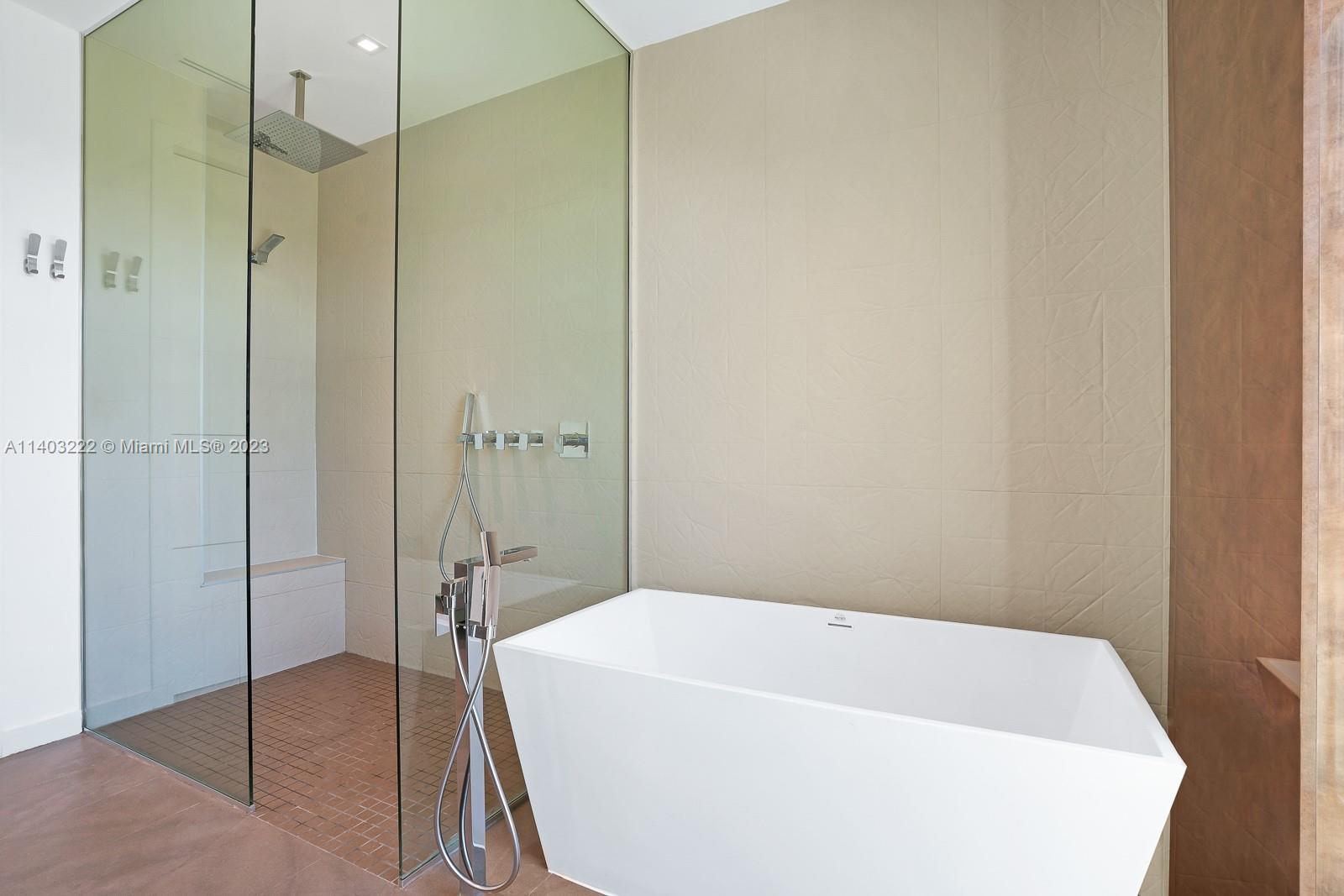 141 Harbor Drive Key Biscayne, FL 33149 - Photo 33 of 56 a bathroom with a bathtub and shower