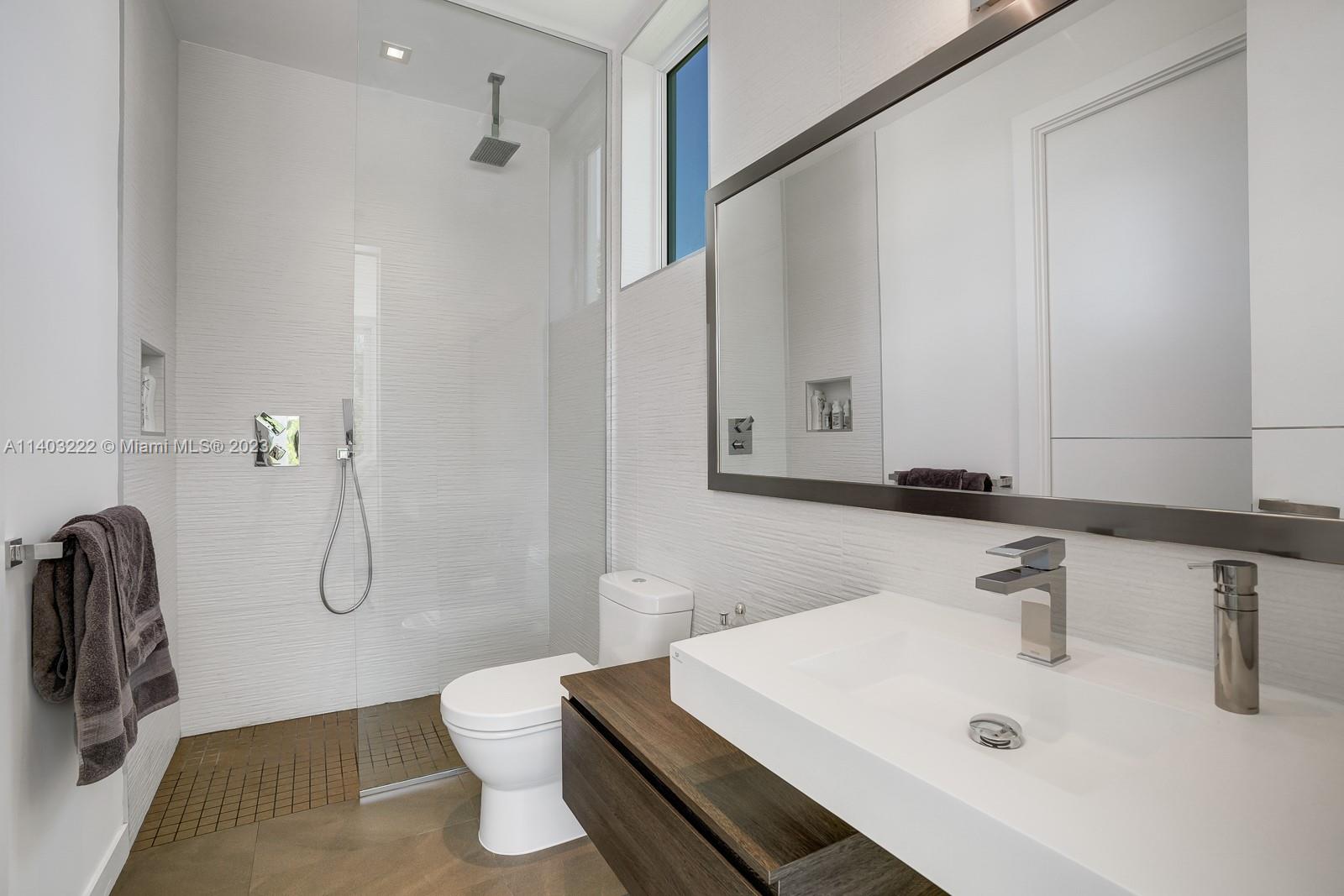 141 Harbor Drive Key Biscayne, FL 33149 - Photo 36 of 56 a bathroom with a sink a toilet and shower