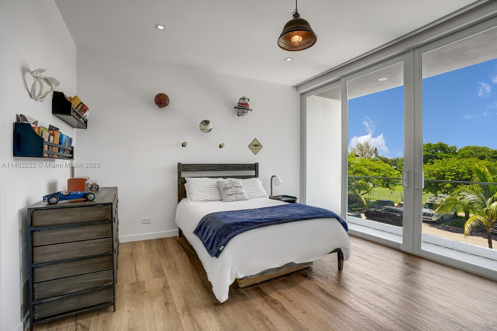 141 Harbor Drive Key Biscayne, FL 33149 - Photo 37 of 56 a bedroom with a bed and a window