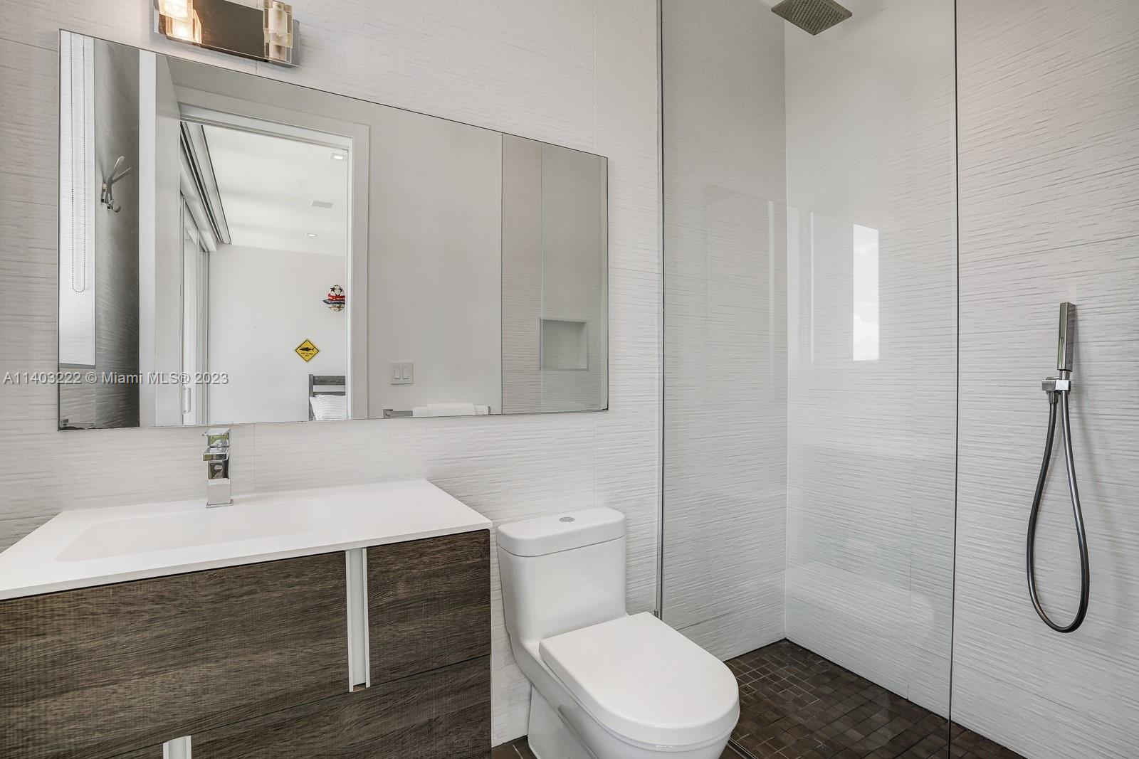 141 Harbor Drive Key Biscayne, FL 33149 - Photo 39 of 56 a bathroom with a sink a toilet and shower