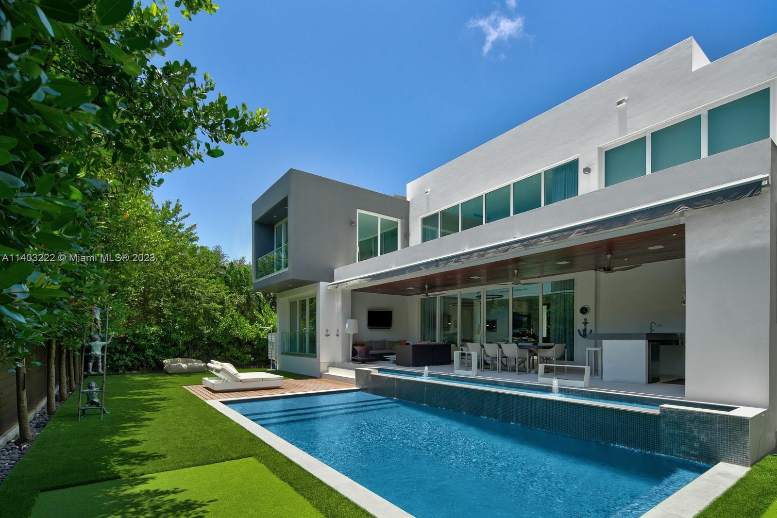 141 Harbor Drive Key Biscayne, FL 33149 - Photo 52 of 56 a view of house with swimming pool outdoor seating and living room