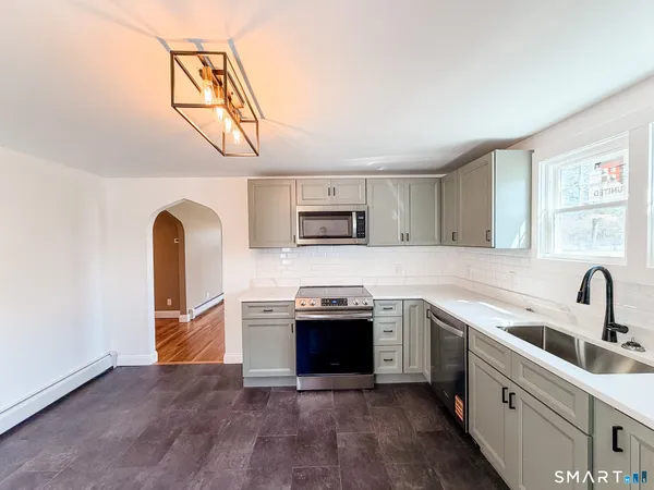 a kitchen with a refrigerator stove and sink
