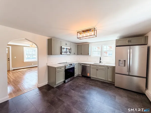 a kitchen with a refrigerator and a sink