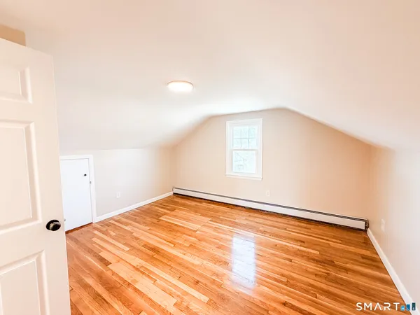 a bedroom with a bed and a lamp on table