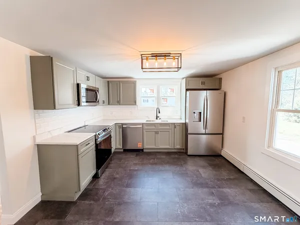 a kitchen with a stove top oven sink and refrigerator