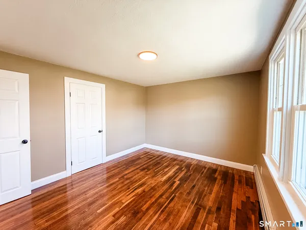 a view of an empty room and wooden floor