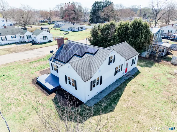 a aerial view of a house with pool and a yard