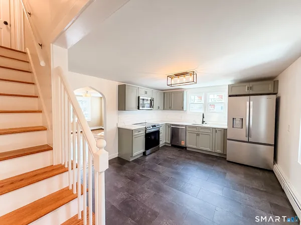 a kitchen with a refrigerator sink and cabinets